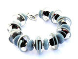 Black And Gray Glass Beaded Bracelet-a gorgeous neutral colored bracelet to rely on in your wardrobe all year long! See it up close here https://wrist-flair.myshopify.com/collections/statement-bracelets/products/gray-and-black-statement-bracelet