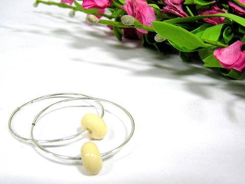 cream beaded sterling silver hoop earrings--a great staple piece of jewelry every woman should have for her wardrobe. See these up close by visiting https://wrist-flair.myshopify.com/collections/beaded-earrings/products/beige-beaded-sterling-silver-hoop-earrings