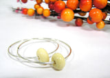 off white glass beaded sterling silver hoop earrings--simple hoop earrings with a touch of color! Learn more about these glass beaded earrings by visiting https://wrist-flair.myshopify.com/collections/beaded-earrings/products/beige-beaded-sterling-silver-hoop-earrings