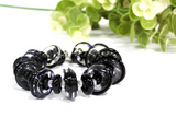 Chunky Black Statement Bracelet--featuring handmade glass beads a a silver toggle. If you're looking for dressy black jewelry that is elegant and noticeable, check out this bracelet by visiting https://wrist-flair.myshopify.com/collections/statement-bracelets/products/black-glass-beaded-bracelet