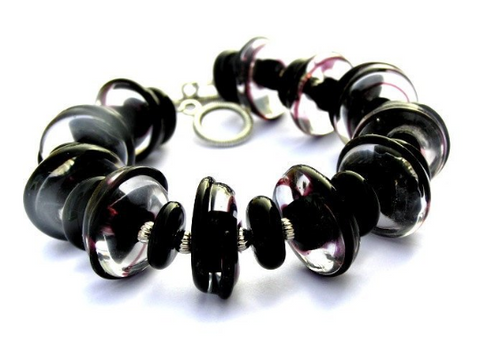 Black Glass Beaded Statement Bracelet--are you searching for modern yet timeless jewelry that is always in style yet makes a STATEMENT with your look? Check out this stunning black glass beaded toggle bracelet here https://wrist-flair.myshopify.com/collections/statement-bracelets/products/black-glass-beaded-bracelet