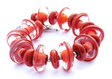 Coral Beaded Bracelet--the 2019 color of the year: Living Coral. This gorgeous glass beaded statement bracelet features the ever-so-popular color in a stunning design. See it up close at https://wrist-flair.myshopify.com/collections/statement-bracelets/products/coral-statement-bracelet