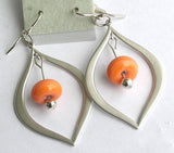 Orange beaded earrings with silver a teardrop design. Shop modern glass beaded jewelry in a variety of colors at http://www.wristflairglass.com