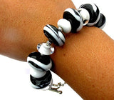 Unique one of a kind black and white beaded bracelet--Do you love animals AND love jewelry or know someone who does?? This black and white beaded toggle bracelet was inspired by zebras! If you're looking for a fun gift for someone who appreciates art, this is a perfect choice! Purchase it by clicking here https://wrist-flair.myshopify.com/collections/statement-bracelets/products/black-and-white-zebra-toggle-bracelet